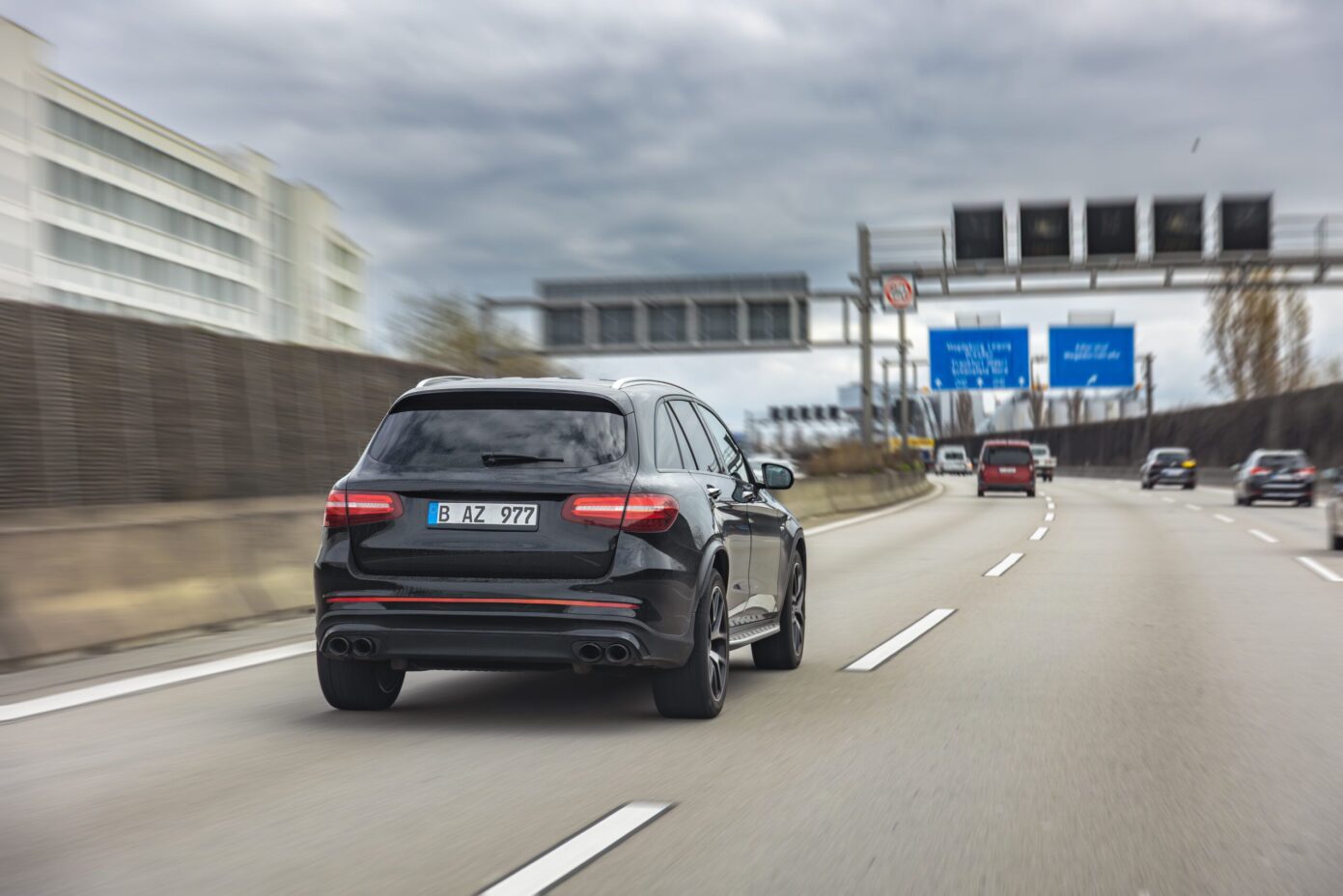 black-premium-suv-driving-city-highway-luxury-car-moves-high-speed-road-berlin